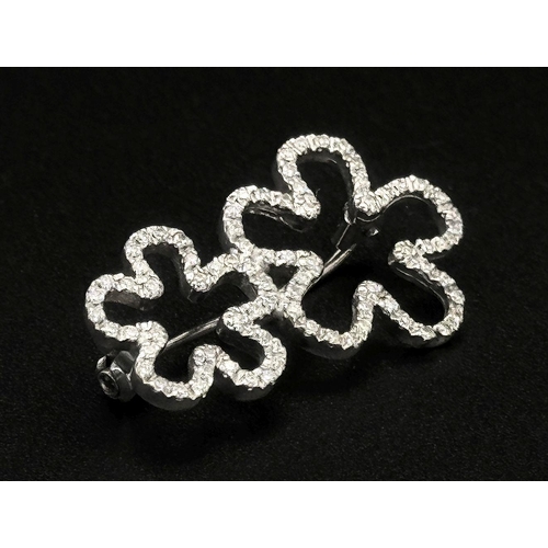 140 - An 18K White Gold and Diamond Brooch. Graduated encrusted stars. 3cm. 4.7g total weight.