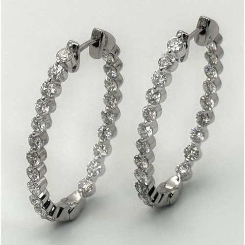 119 - A Pair of 18K White Gold and Diamond Oval Hoop Earrings. 48 diamonds in total - 2ctw approx. 6.3g to... 