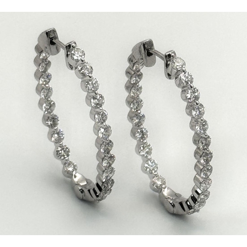 119 - A Pair of 18K White Gold and Diamond Oval Hoop Earrings. 48 diamonds in total - 2ctw approx. 6.3g to... 