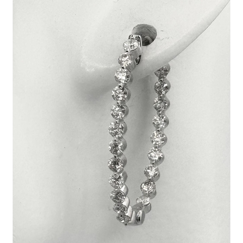 119 - A Pair of 18K White Gold and Diamond Oval Hoop Earrings. 48 diamonds in total - 2ctw approx. 6.3g to... 