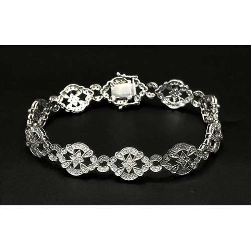 189 - An Art Deco Style 14K White Gold and Diamond Bracelet. 18cm. 10.9g. Five small stones missing so A/F... 