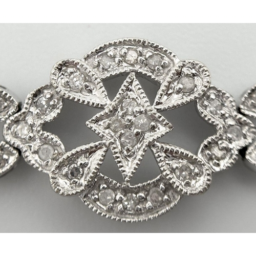 189 - An Art Deco Style 14K White Gold and Diamond Bracelet. 18cm. 10.9g. Five small stones missing so A/F... 