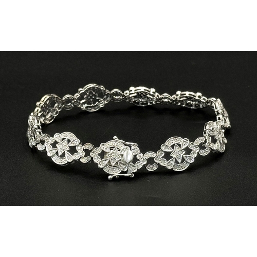 189 - An Art Deco Style 14K White Gold and Diamond Bracelet. 18cm. 10.9g. Five small stones missing so A/F... 