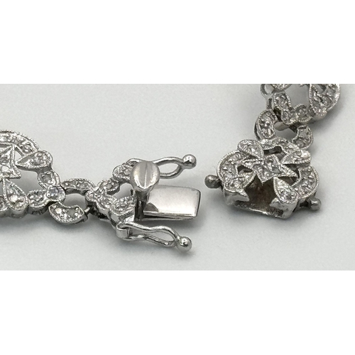 189 - An Art Deco Style 14K White Gold and Diamond Bracelet. 18cm. 10.9g. Five small stones missing so A/F... 