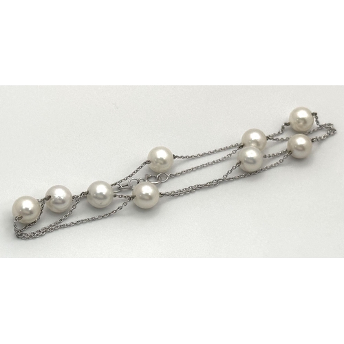 343 - An 18K White Gold Necklace with Nine Pearl Decoration. 7.4g total weight. Pearls, 7/8mm. 44cm length... 
