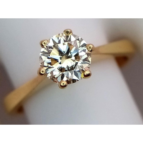 336 - An 18K Yellow Gold Diamond Solitaire Ring. A 0.75ct brilliant round cut diamond - SI1 clarity. Tinte... 