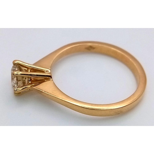 336 - An 18K Yellow Gold Diamond Solitaire Ring. A 0.75ct brilliant round cut diamond - SI1 clarity. Tinte... 
