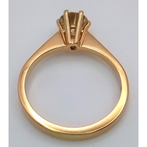 336 - An 18K Yellow Gold Diamond Solitaire Ring. A 0.75ct brilliant round cut diamond - SI1 clarity. Tinte... 