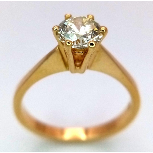336 - An 18K Yellow Gold Diamond Solitaire Ring. A 0.75ct brilliant round cut diamond - SI1 clarity. Tinte... 
