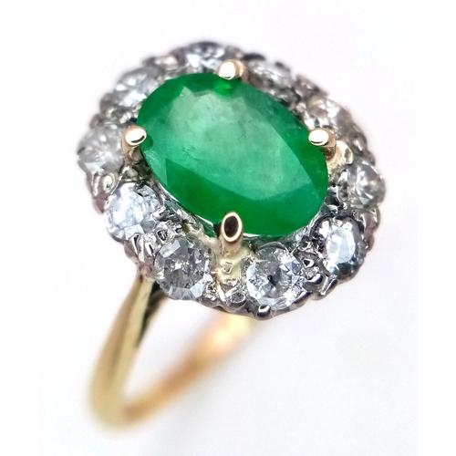 357 - An 18K Yellow Gold, Emerald and Diamond Ring. A 1.3ct oval cut central emerald with a 1ctw brilliant... 