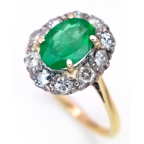 357 - An 18K Yellow Gold, Emerald and Diamond Ring. A 1.3ct oval cut central emerald with a 1ctw brilliant... 