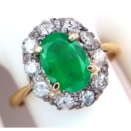 357 - An 18K Yellow Gold, Emerald and Diamond Ring. A 1.3ct oval cut central emerald with a 1ctw brilliant... 