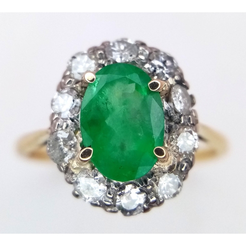 357 - An 18K Yellow Gold, Emerald and Diamond Ring. A 1.3ct oval cut central emerald with a 1ctw brilliant... 