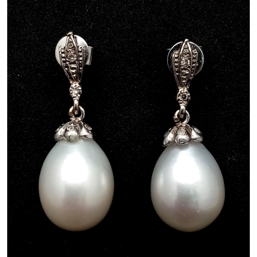 431 - A Pair of Vintage 18K White Gold, Diamond and Pearl Earrings. Large 15mm oval pearls. 8.1g total wei... 