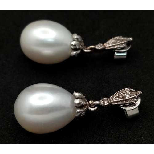 431 - A Pair of Vintage 18K White Gold, Diamond and Pearl Earrings. Large 15mm oval pearls. 8.1g total wei... 
