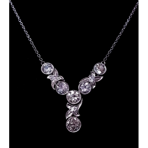 56 - An Art Deco Platinum and Diamond Lavaliere Necklace. 3.2ctw of old European round cut diamonds with ... 