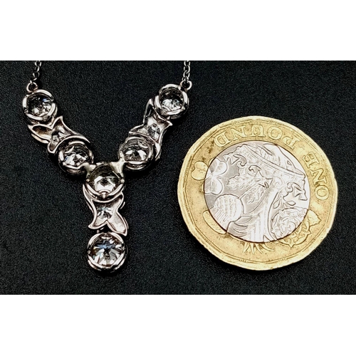 56 - An Art Deco Platinum and Diamond Lavaliere Necklace. 3.2ctw of old European round cut diamonds with ... 
