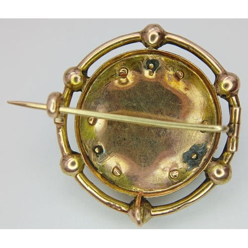 438 - An Antique 18K Gold, Pearl and Garnet Circular Brooch. Central blood red garnet cabochon with a pear... 