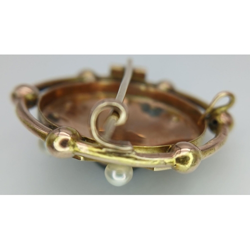 438 - An Antique 18K Gold, Pearl and Garnet Circular Brooch. Central blood red garnet cabochon with a pear... 