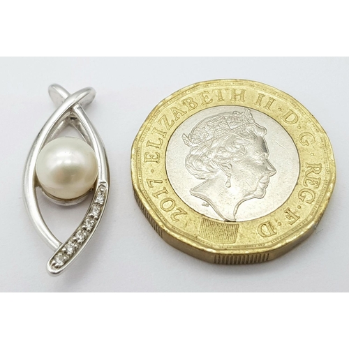 382 - A 9K White Gold, Pearl, and diamond Eye of Horus Pendant. 2.4g total weight.
