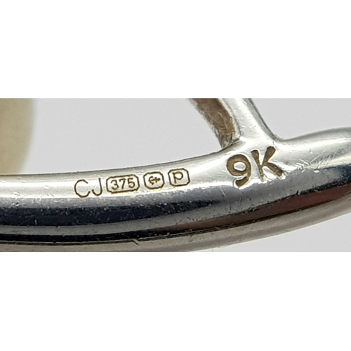 382 - A 9K White Gold, Pearl, and diamond Eye of Horus Pendant. 2.4g total weight.
