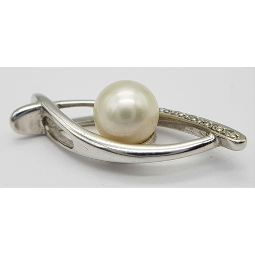 382 - A 9K White Gold, Pearl, and diamond Eye of Horus Pendant. 2.4g total weight.
