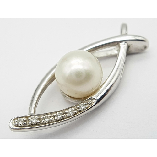 382 - A 9K White Gold, Pearl, and diamond Eye of Horus Pendant. 2.4g total weight.