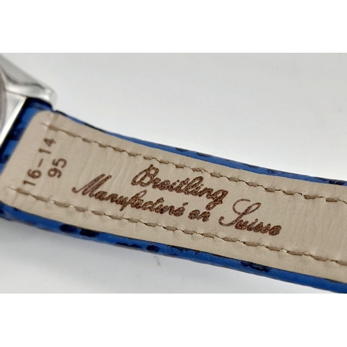 105 - A Breitling (A 71356) Ladies Quartz Watch. Blue leather strap. Stainless steel case - 32mm. Mother o... 