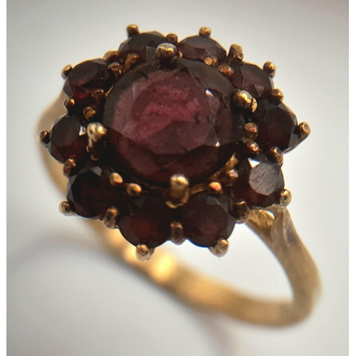 375 - An 18K Yellow Gold Garnet Floral Cluster Ring. Size P, 3.69g total weight.