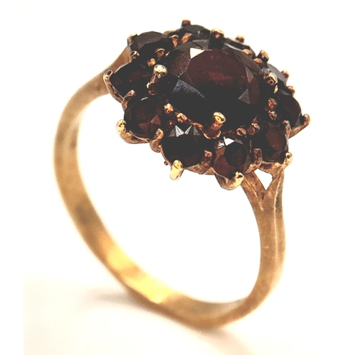 375 - An 18K Yellow Gold Garnet Floral Cluster Ring. Size P, 3.69g total weight.