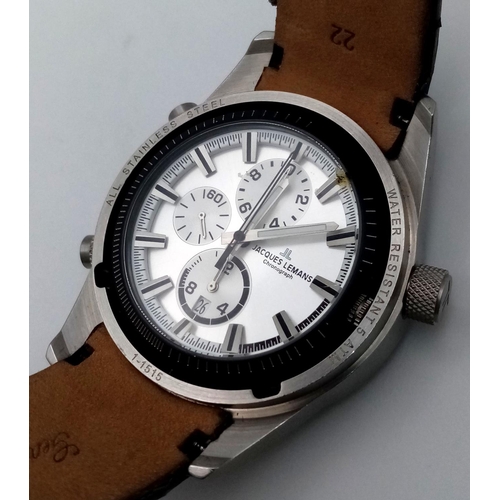396 - A Jacques Lemans Dualtime Chronograph Gents Watch. Silver tone face with three sub dials and a class... 