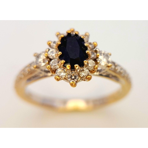 446 - An 18K Gold Sapphire and White Stone Ring. Size N. 3.3g