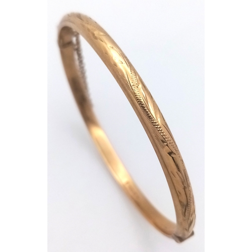 244 - A Vintage 9K Yellow Gold Bangle. Clip design and safety chain. 6.7g.