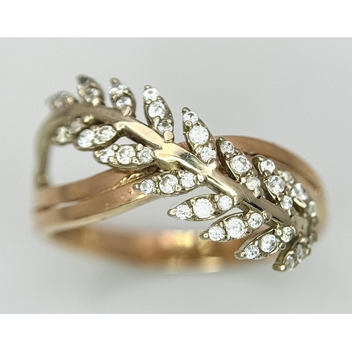 776 - An 18K Yellow Gold Diamond Leaf Form Crossover Ring. Size O 1/2. 3.2g