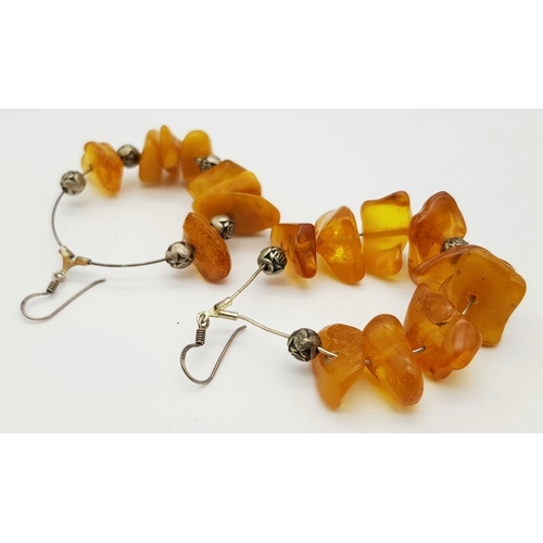 835 - A Pair of Natural Amber Hoop Earrings. 17g
