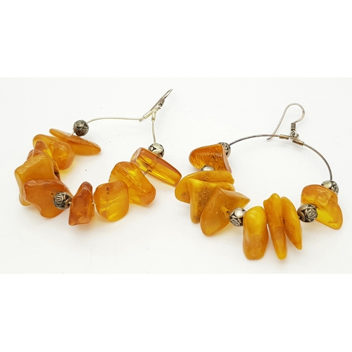 835 - A Pair of Natural Amber Hoop Earrings. 17g