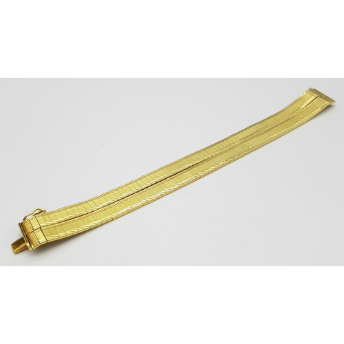 5 - A Tier One, Attractive, 18K Yellow Gold Two Row Bangle. Twin geometric pattern paved design with a c... 