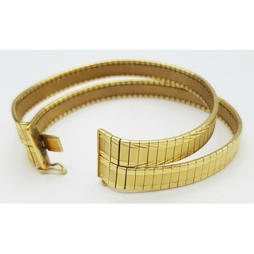 5 - A Tier One, Attractive, 18K Yellow Gold Two Row Bangle. Twin geometric pattern paved design with a c... 