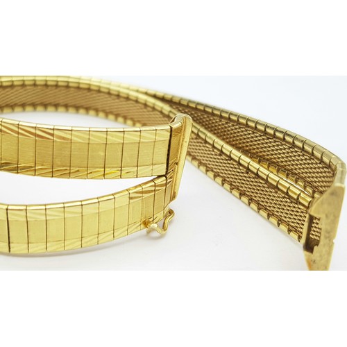 5 - A Tier One, Attractive, 18K Yellow Gold Two Row Bangle. Twin geometric pattern paved design with a c... 