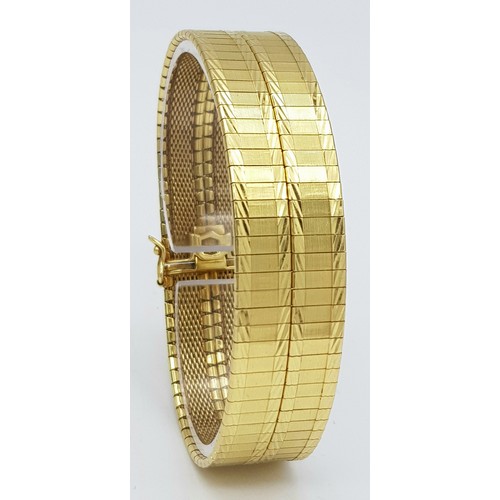 5 - A Tier One, Attractive, 18K Yellow Gold Two Row Bangle. Twin geometric pattern paved design with a c... 