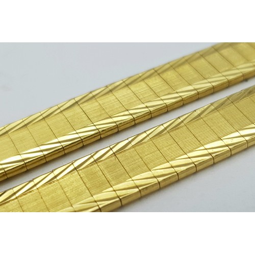 5 - A Tier One, Attractive, 18K Yellow Gold Two Row Bangle. Twin geometric pattern paved design with a c... 