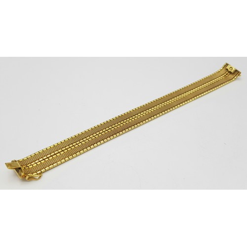 5 - A Tier One, Attractive, 18K Yellow Gold Two Row Bangle. Twin geometric pattern paved design with a c... 