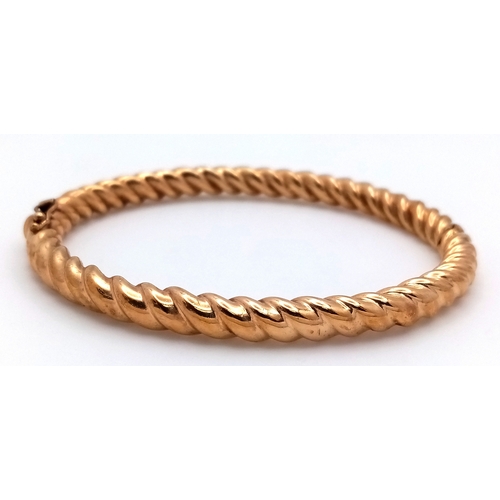 6 - A 9K Yellow Gold Decorative Ridged Bangle. Clip-open design. 6cm inner diameter. 14.85g