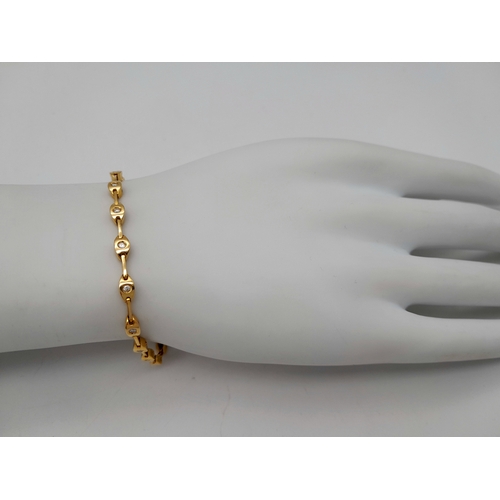 27 - A Stylish 18K Yellow Gold Diamond Tennis Bracelet. 16cm. 10g