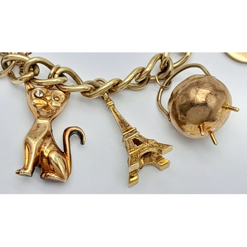 693 - A 9K GOLD CHARM BRACELET WITH 7 CHARMS TO INCLUDE A GOOD LUCK HORSESHOE,THE EIFFEL TOWER , A NICE CU... 