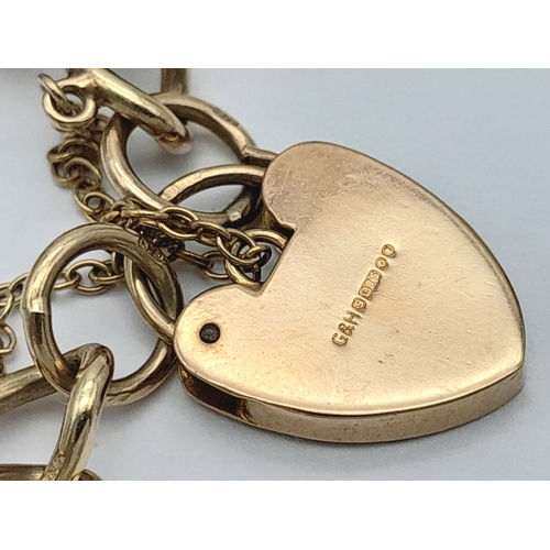 693 - A 9K GOLD CHARM BRACELET WITH 7 CHARMS TO INCLUDE A GOOD LUCK HORSESHOE,THE EIFFEL TOWER , A NICE CU... 