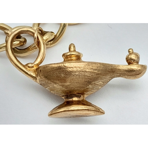 693 - A 9K GOLD CHARM BRACELET WITH 7 CHARMS TO INCLUDE A GOOD LUCK HORSESHOE,THE EIFFEL TOWER , A NICE CU... 