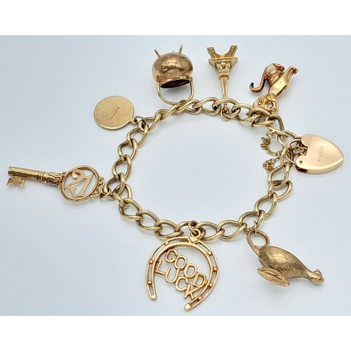 693 - A 9K GOLD CHARM BRACELET WITH 7 CHARMS TO INCLUDE A GOOD LUCK HORSESHOE,THE EIFFEL TOWER , A NICE CU... 