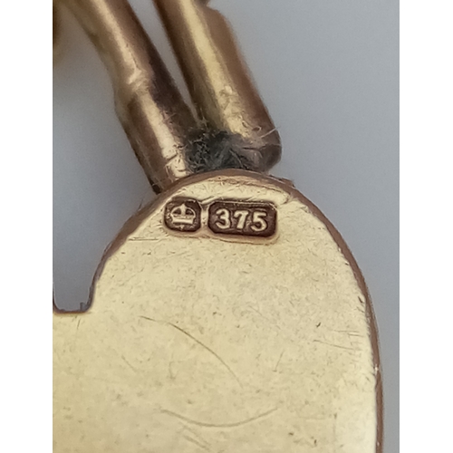 700 - A Well Constructed 9K Yellow Gold Gate Bracelet with Heart Charm and Safety Chain. 16cm. 28.75g