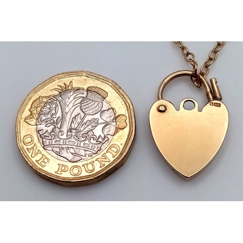 700 - A Well Constructed 9K Yellow Gold Gate Bracelet with Heart Charm and Safety Chain. 16cm. 28.75g
